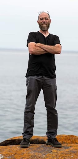 John Davis on shore of lake