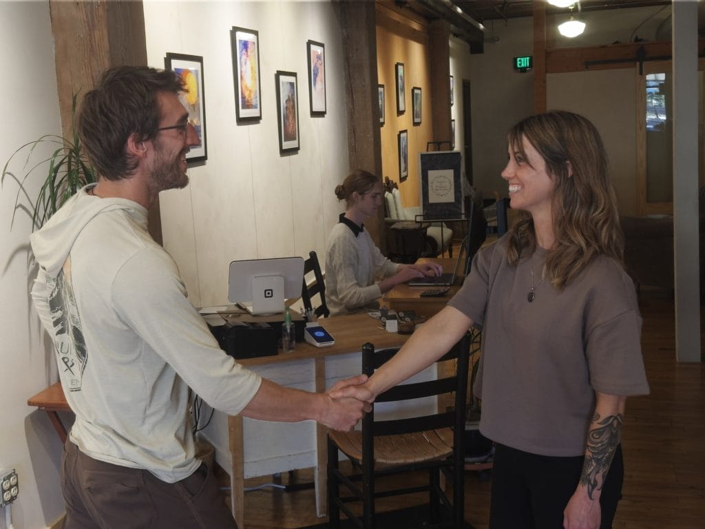 Acupuncturist Jakki Overby greets a client at Halcyon House's front desk.