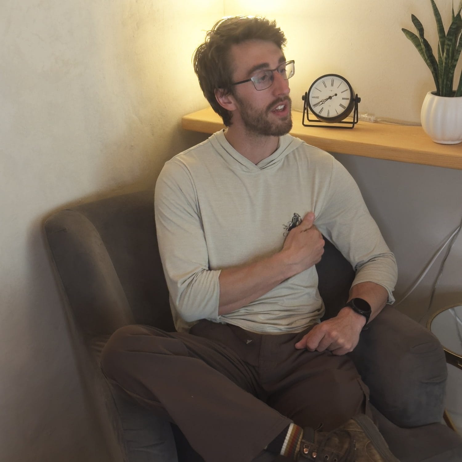 Acupuncturist Jakki Overby reviews a client's health history, past health issues, and current treatment goals. The client motions toward their shoulder as a focus area for acupuncture treatment.